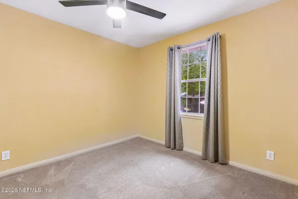 an empty room with a empty space and windows