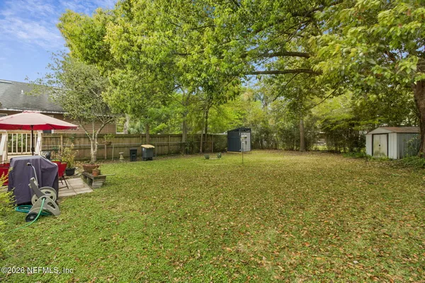a backyard of a house with table and chairs