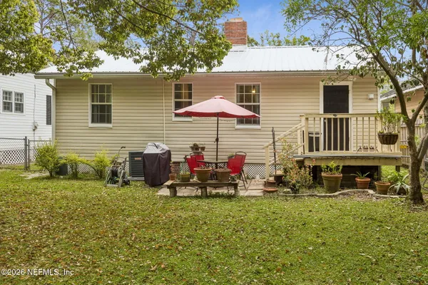 a view of a house with backyard and sitting area