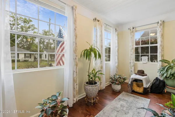 a living room filled with furniture window and potted plant