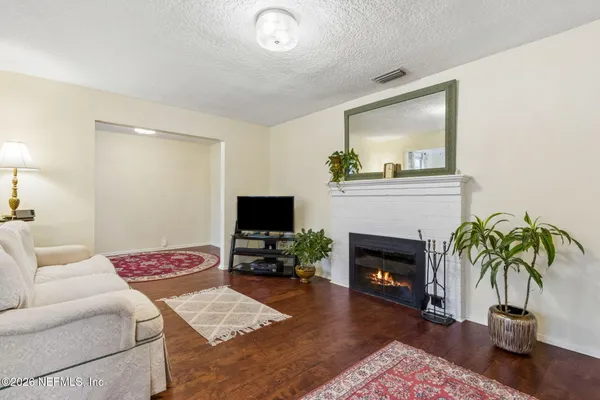 a living room with furniture and a fireplace