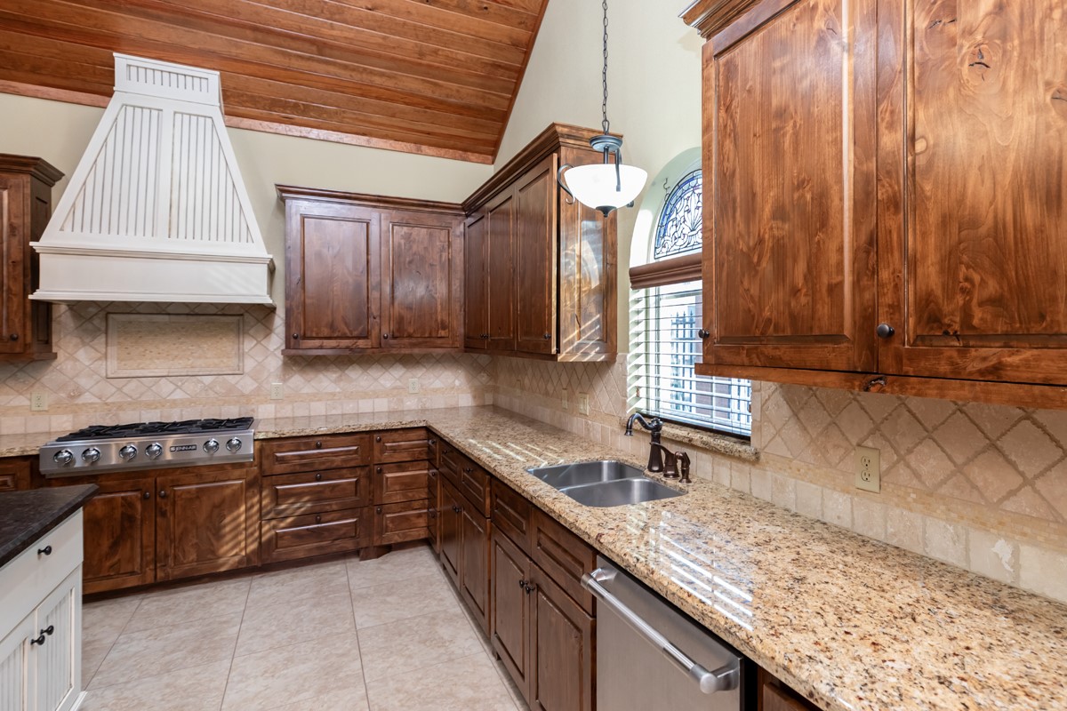 3365 Esplanade Beaumont, TX 77707 - Photo 11 of 33 a kitchen with granite countertop a sink a counter space and cabinets