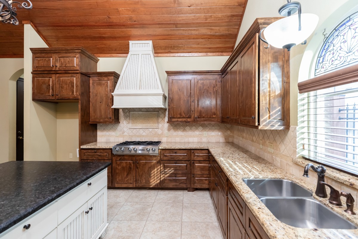3365 Esplanade Beaumont, TX 77707 - Photo 12 of 33 a kitchen with granite countertop a sink a stove and cabinets