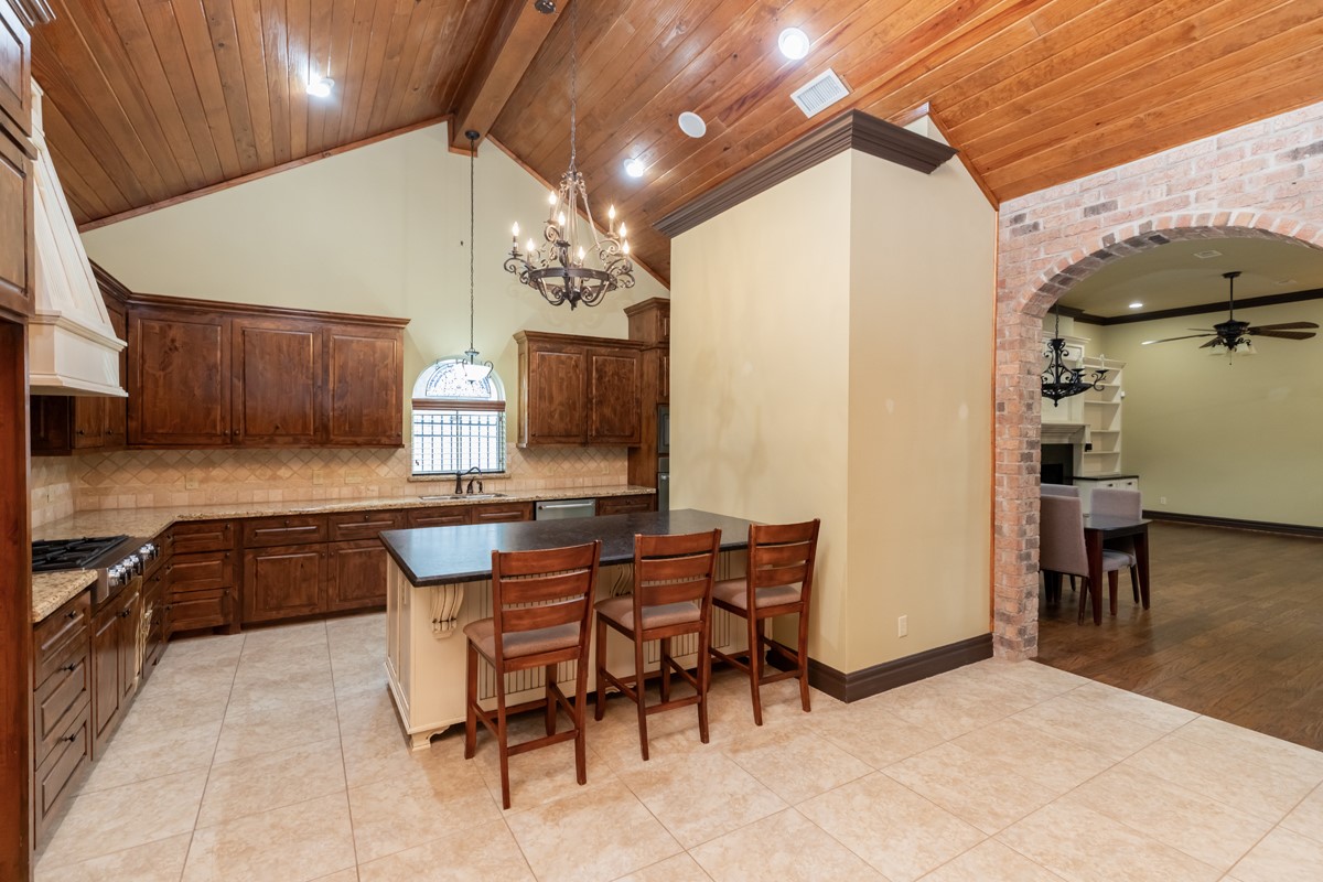 3365 Esplanade Beaumont, TX 77707 - Photo 16 of 33 a kitchen with granite countertop a sink cabinets and stove top oven