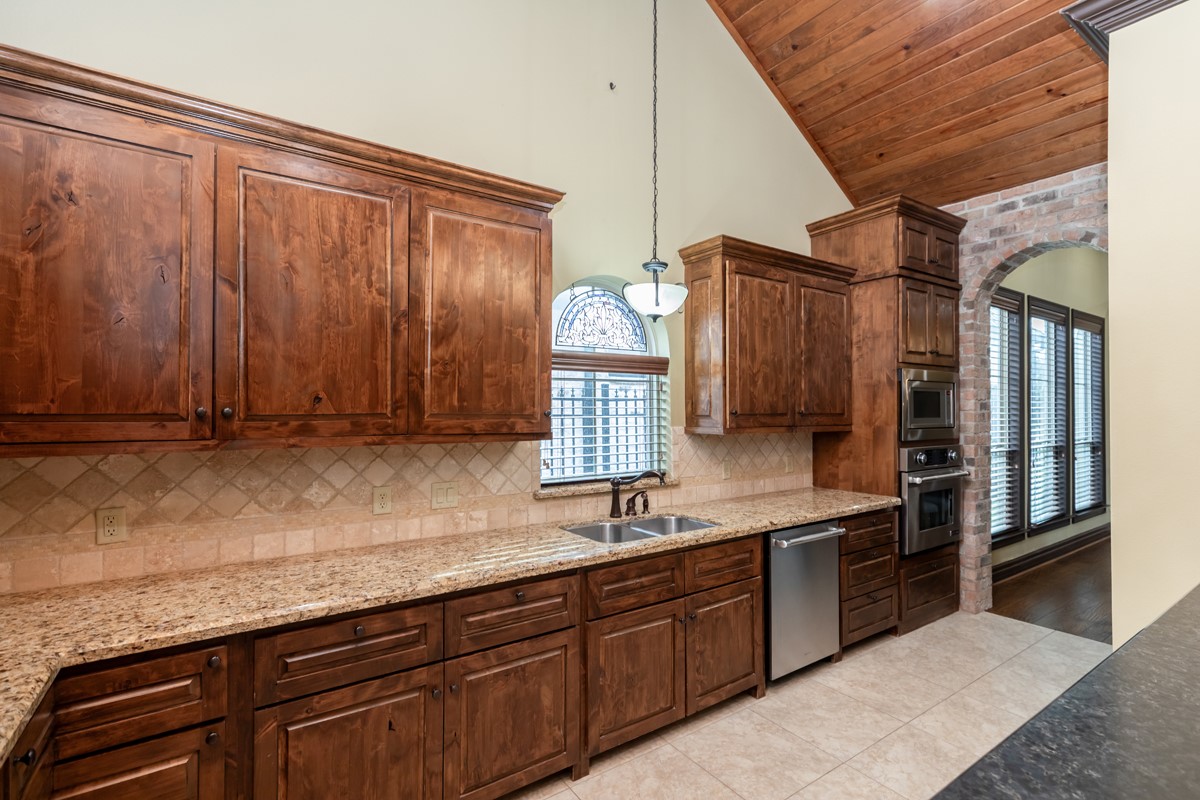 3365 Esplanade Beaumont, TX 77707 - Photo 18 of 33 a kitchen with stainless steel appliances granite countertop a sink a stove and a refrigerator