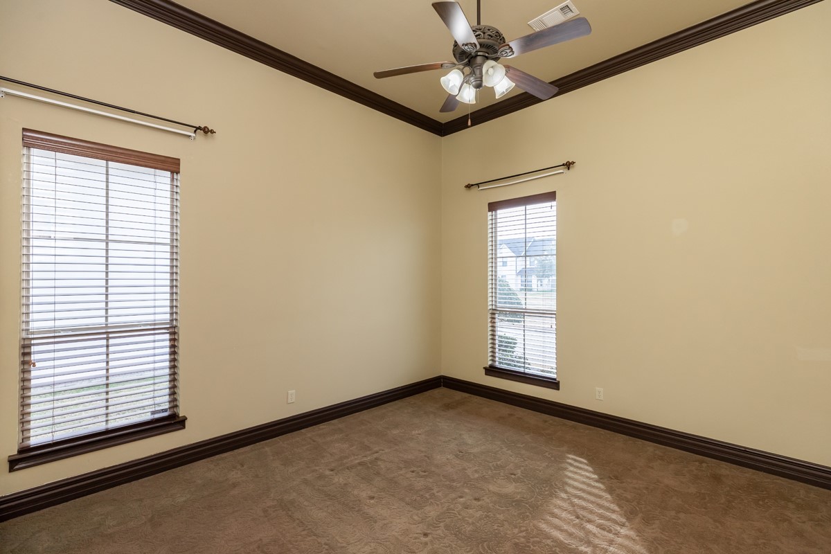 3365 Esplanade Beaumont, TX 77707 - Photo 27 of 33 an empty room with a chandelier fan and windows