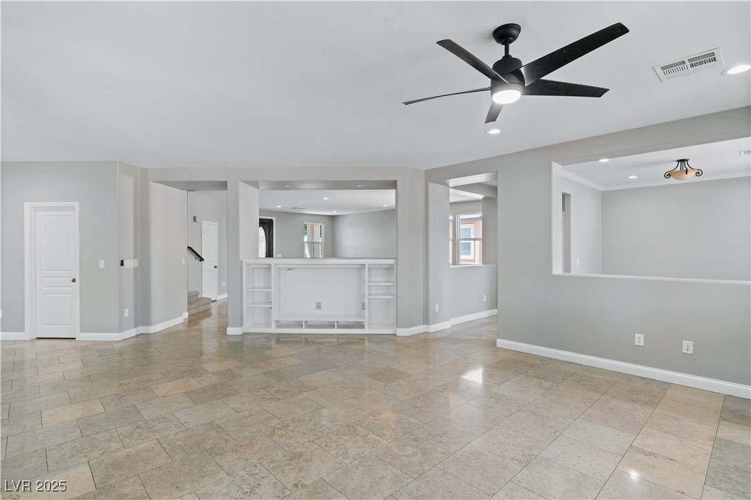 312 Pocono Ranch Avenue North Las Vegas, NV 89031 - Photo 10 of 34 Unfurnished living room featuring recessed lighting, stairs, ceiling fan, baseboards, and visible vents