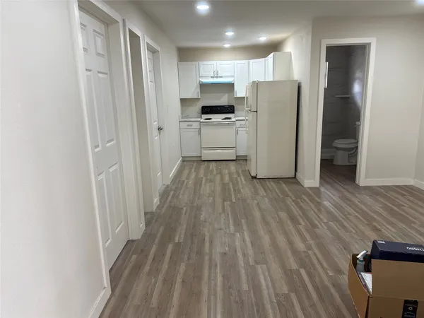 a kitchen with a refrigerator a sink and cabinets