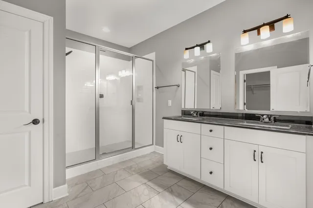 a bathroom with a granite countertop sink mirror and a