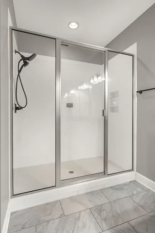 a bathroom with a glass shower door