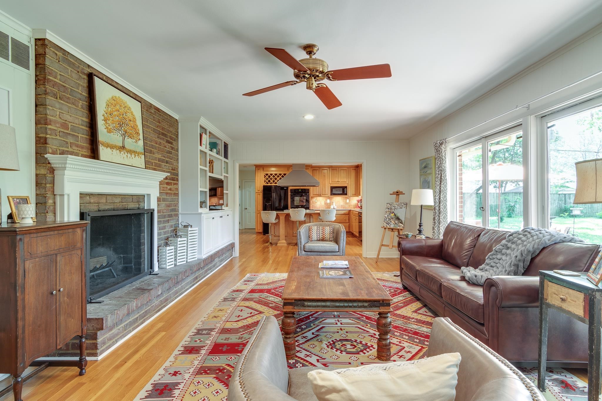 4263 Burgundy Road Memphis, TN 38111 - Photo 12 of 38 Spacious den features a 2nd fireplace, built-in shelving and cabinets, wood flooring, brick wall and is open to the Kitchen.