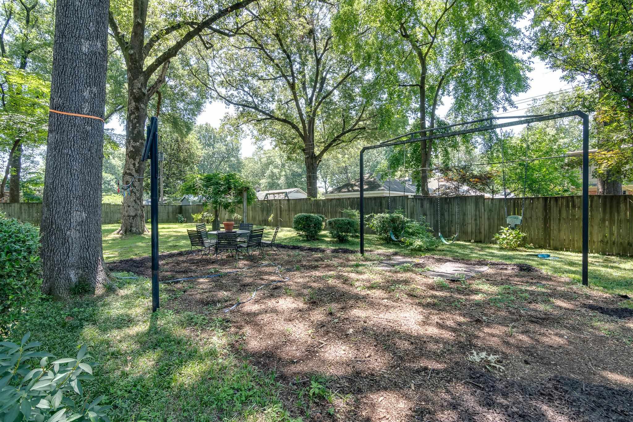 4263 Burgundy Road Memphis, TN 38111 - Photo 34 of 38 2nd table and chairs in backyard near the swings