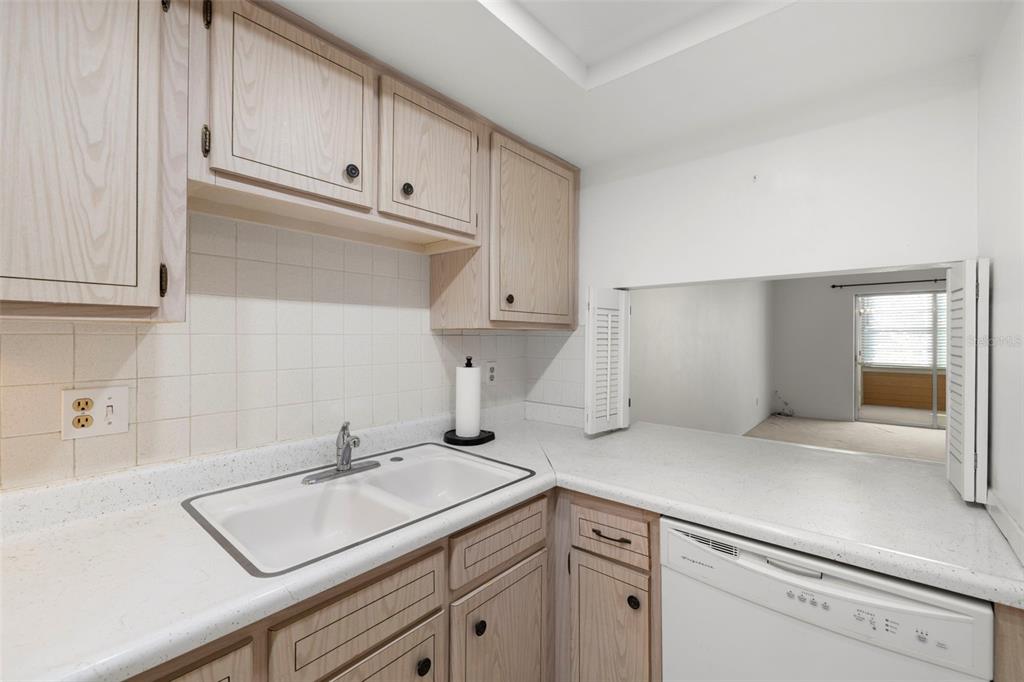 400 Glennes Lane, Unit 206 Dunedin, FL 34698 - Photo 11 of 49 a kitchen with a sink and cabinets