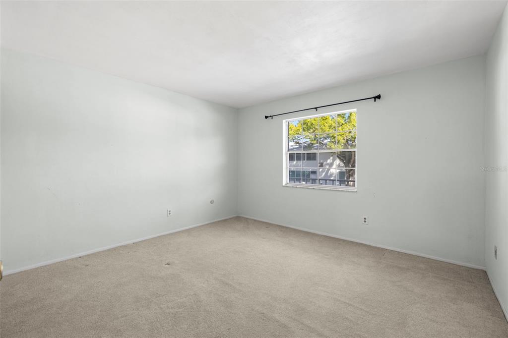 400 Glennes Lane, Unit 206 Dunedin, FL 34698 - Photo 14 of 49 an empty room with windows