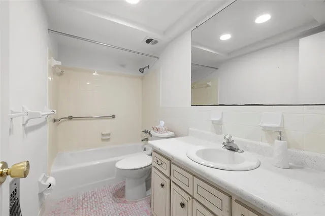 a bathroom with a sink double vanity granite toilet tub and shower
