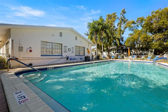 a view of a living room hardwood floor and a kitchen