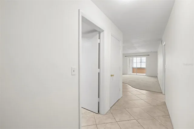 a view of hallway with a sink and a mirror