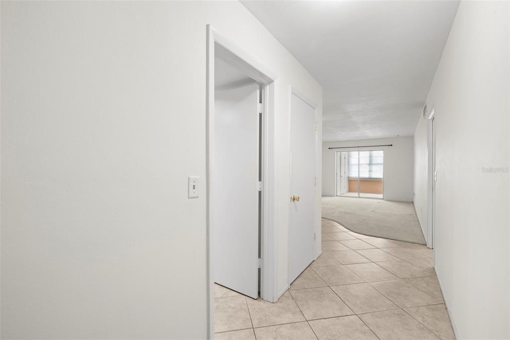 400 Glennes Lane, Unit 206 Dunedin, FL 34698 - Photo 3 of 49 a view of hallway with a sink and a mirror
