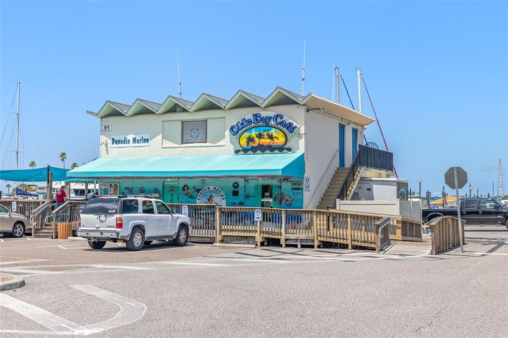 400 Glennes Lane, Unit 206 Dunedin, FL 34698 - Photo 40 of 49 a car parked in front of a building