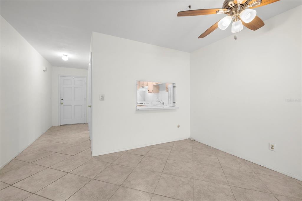 400 Glennes Lane, Unit 206 Dunedin, FL 34698 - Photo 8 of 49 an empty room with fan and windows