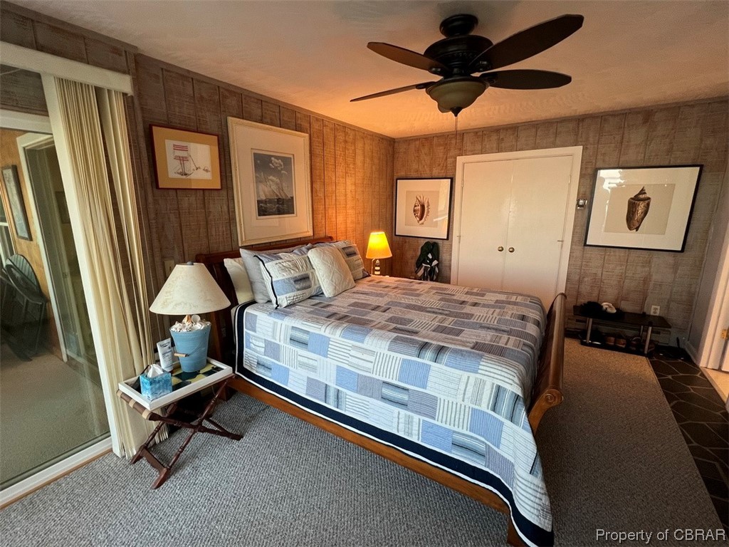 790 Long Point Lane Topping, VA 23169 - Photo 11 of 26 Bedroom with dark carpet, a closet, and ceiling fan