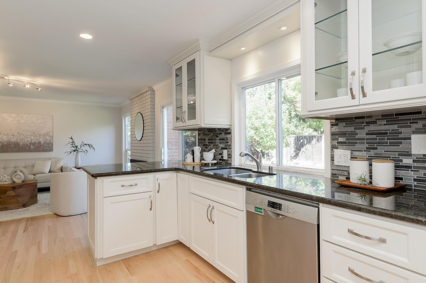 632 Smoke Tree Way Sunnyvale, CA 94086 - Photo 14 of 38 a kitchen with white cabinets a sink a window and appliances