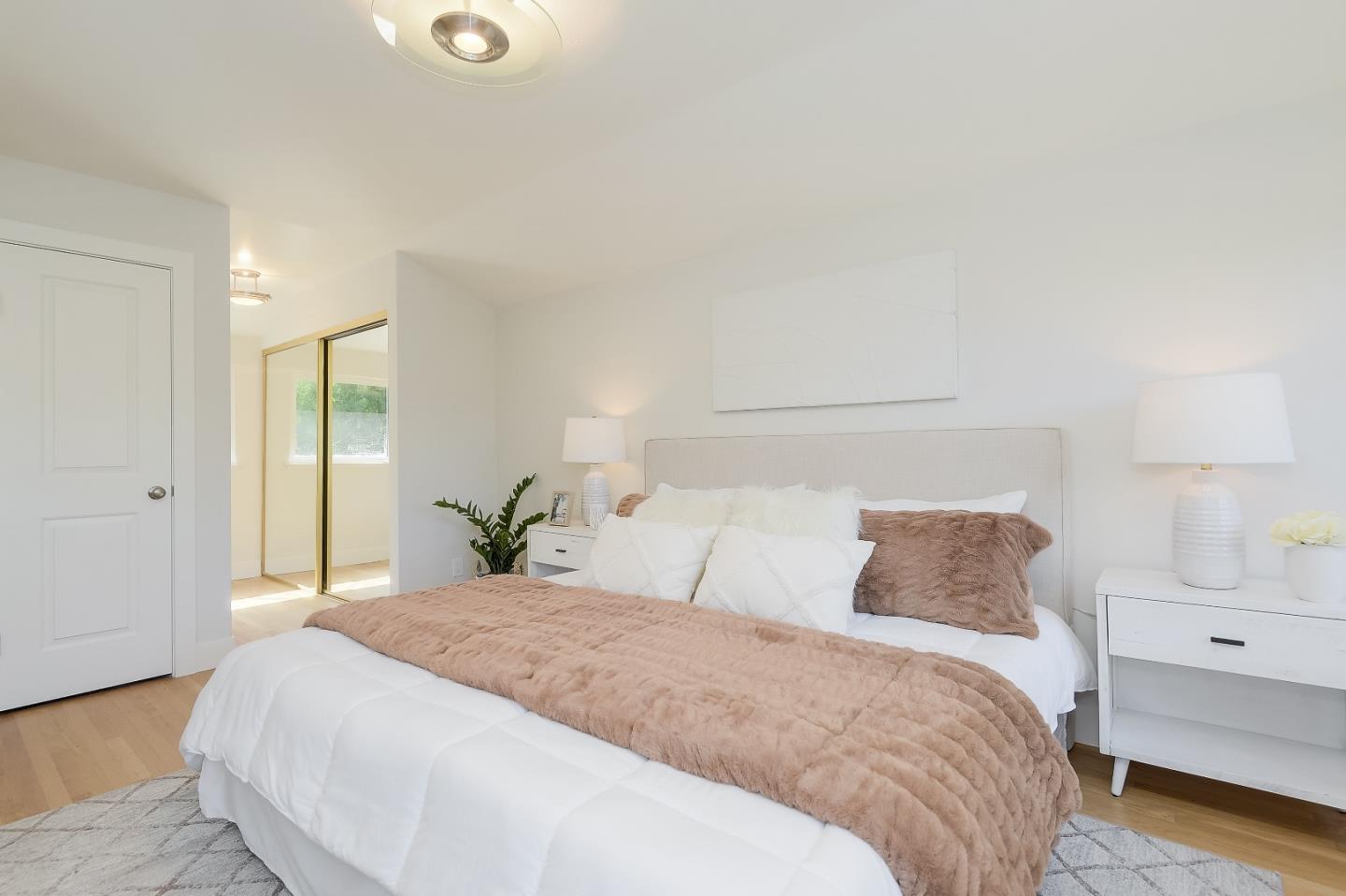 632 Smoke Tree Way Sunnyvale, CA 94086 - Photo 29 of 38 a bedroom with a large bed and lamps