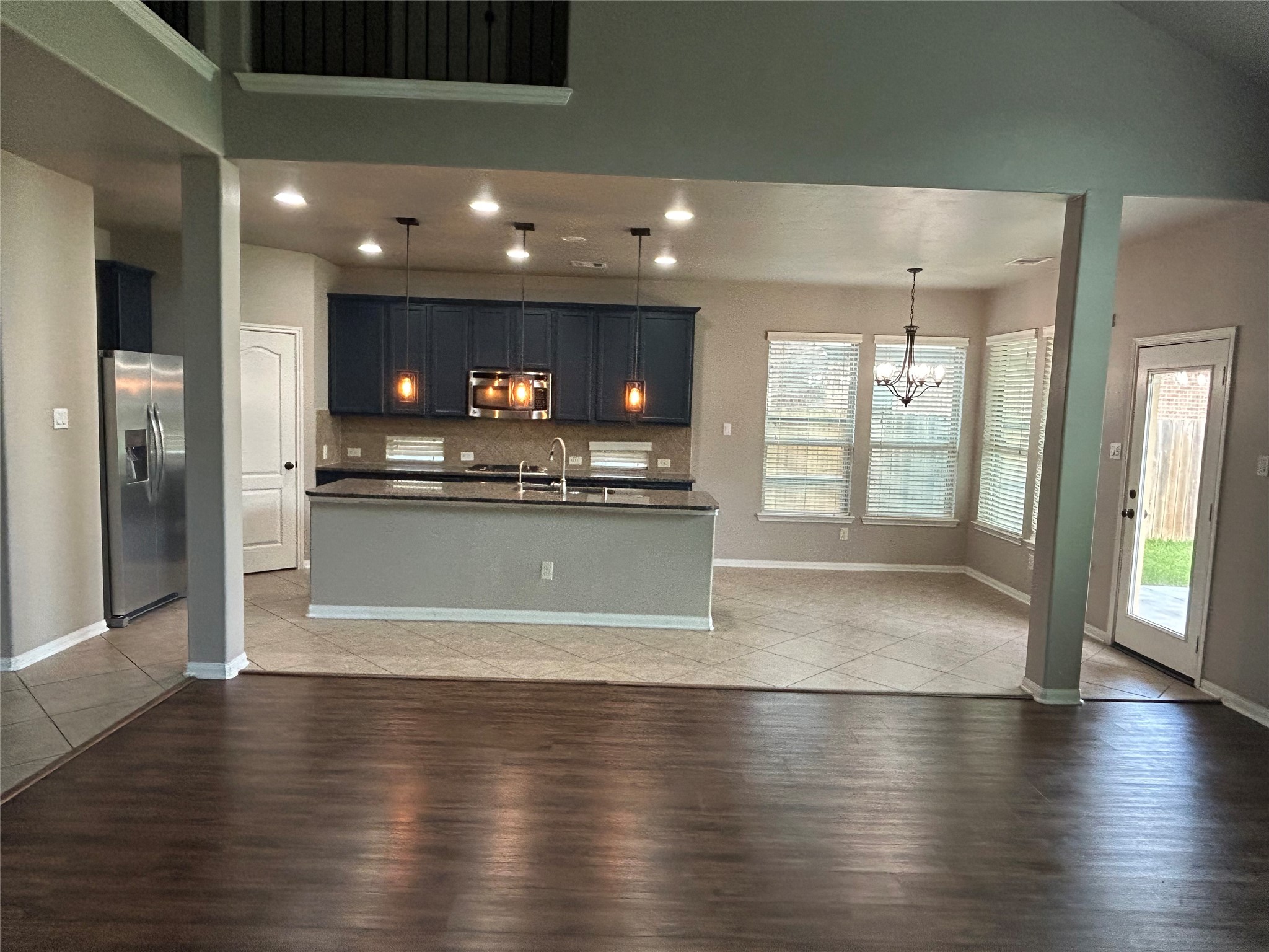 7936 Lake Commons Drive Rosenberg, TX 77469 - Photo 33 of 33 a view of a kitchen with refrigerator and wooden floor