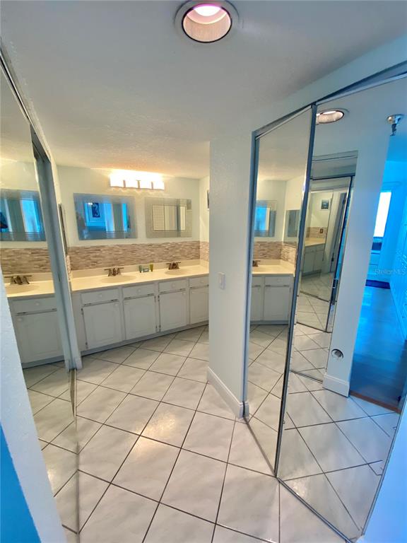6035 Sea Ranch Drive, Unit 901 Hudson, FL 34667 - Photo 12 of 72 a bathroom with a sink a toilet and a mirror