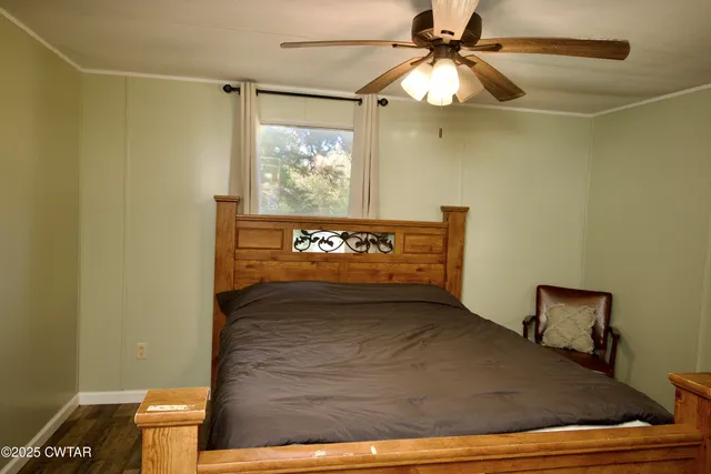 a view of a livingroom with wooden floor and furniture