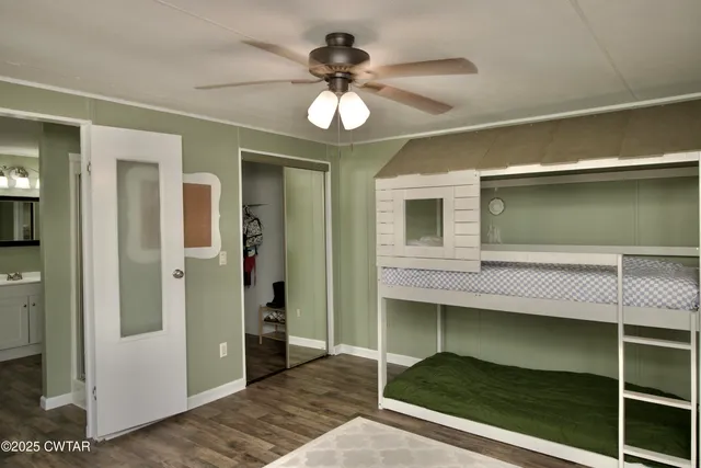 a view of a livingroom with a window and wooden floor