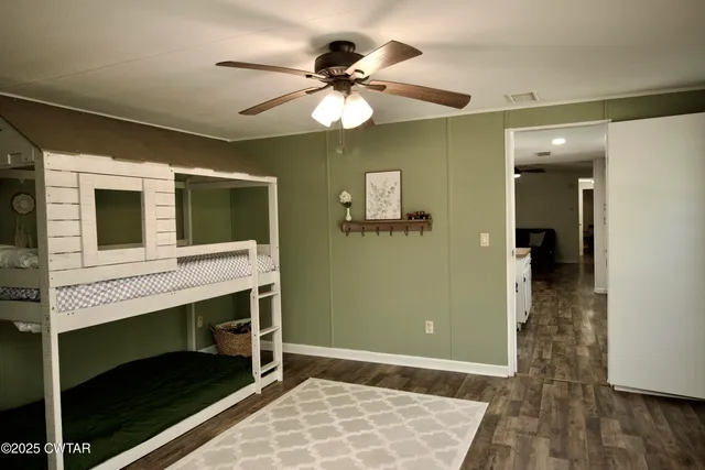 a spacious bathroom with a toilet sink and mirror