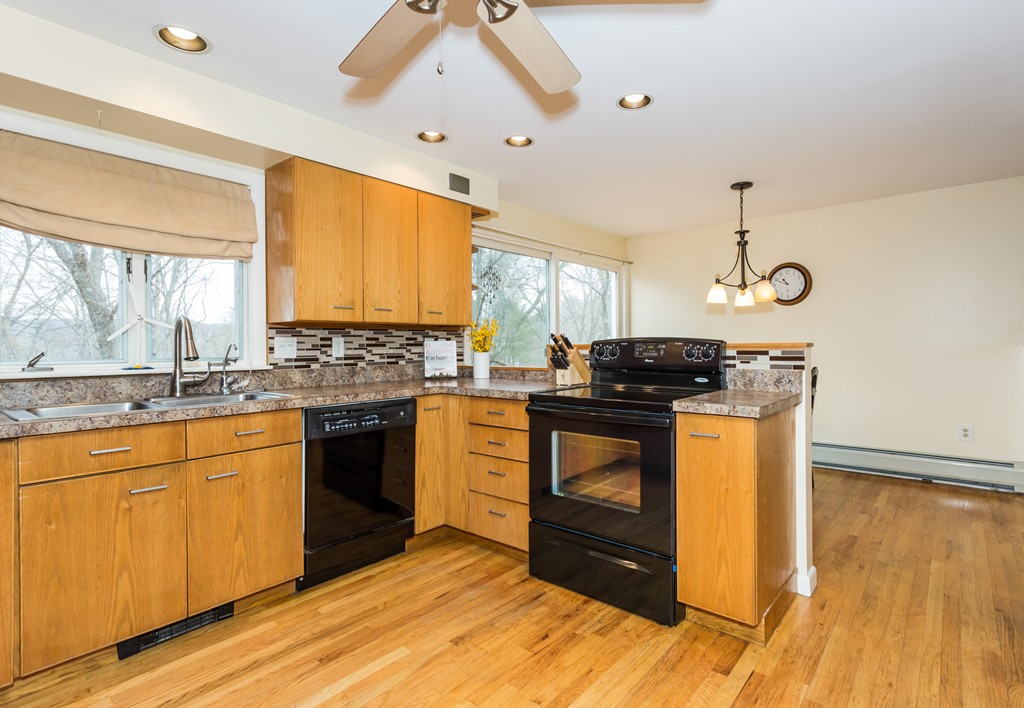 1174 Bay Road Amherst, MA 01002 - Photo 10 of 30 a kitchen with stainless steel appliances granite countertop a stove a sink and a microwave