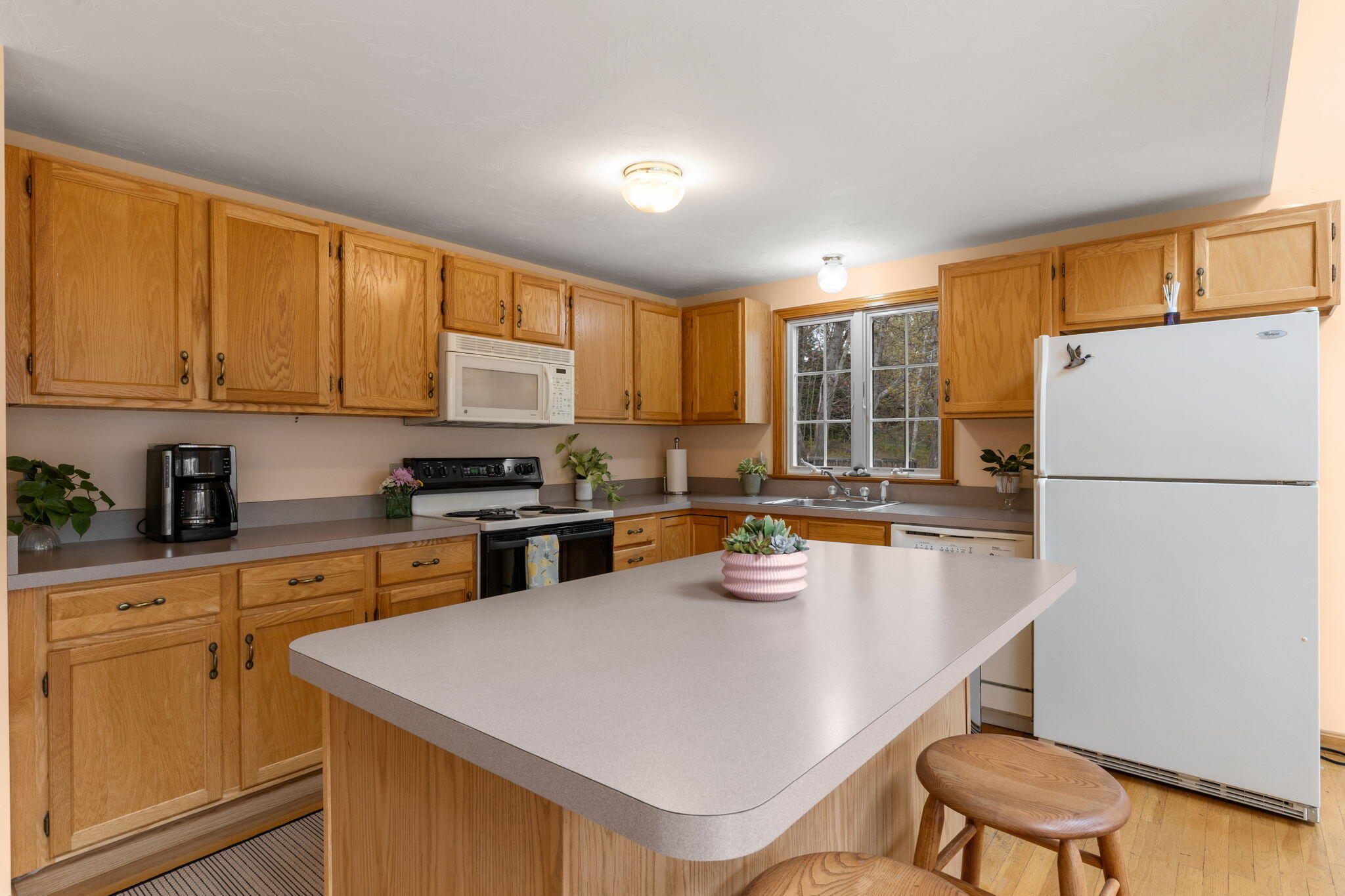 285 Blue Heron Road Wellfleet, MA 02667 - Photo 3 of 31 a kitchen with a refrigerator a stove a sink dishwasher with a dining table and chairs