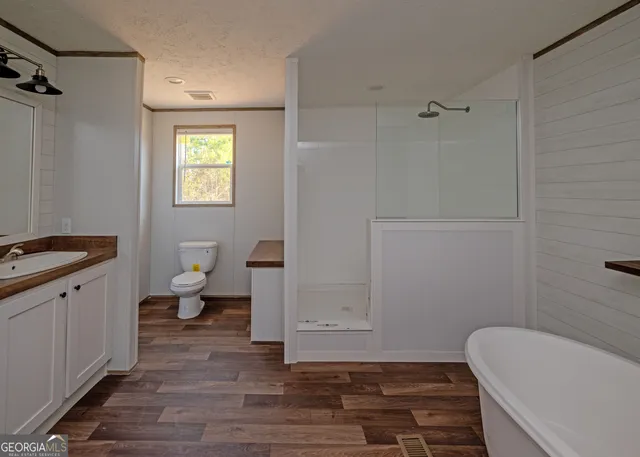 a bathroom with a toilet a sink and bathtub