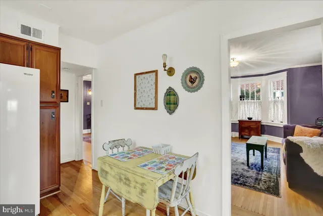 a spacious bedroom with a bed and a dresser in it