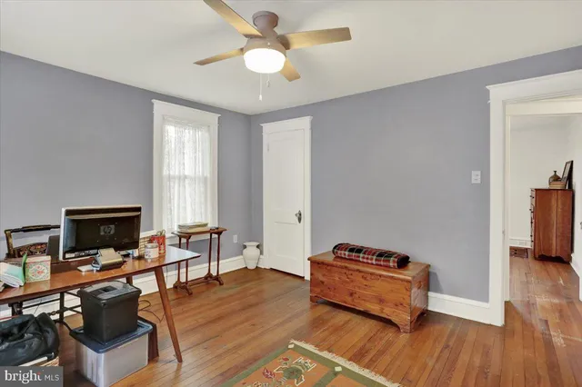 a view of a livingroom with wooden floor and a window