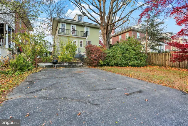 a view of a house with a yard and potted plants