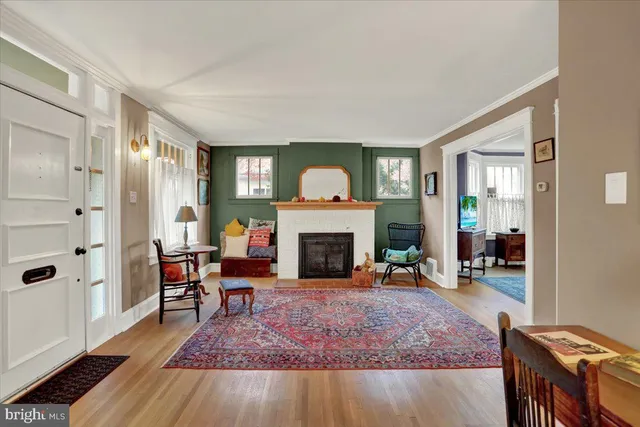 a living room with furniture a fireplace and a table