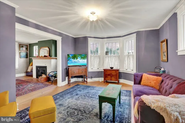 a living room with furniture a rug and a window