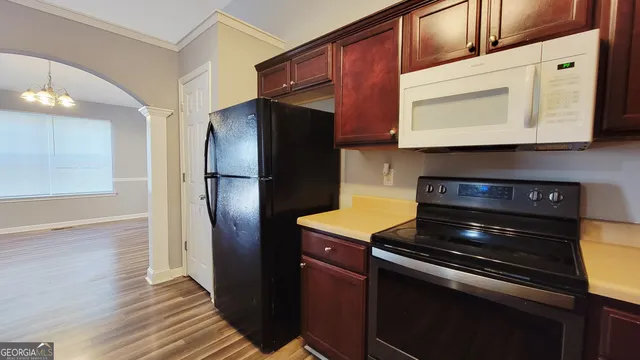 a kitchen with stainless steel appliances granite countertop a refrigerator and a stove