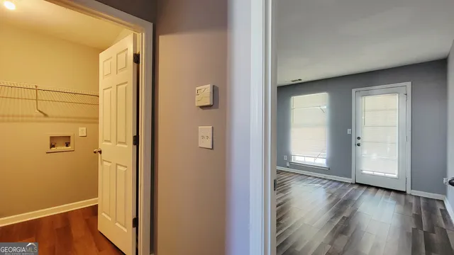 a view of a room with wooden floor and closet