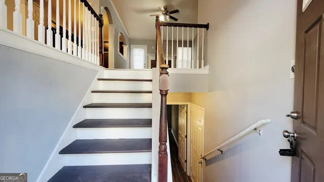 a view of staircase with white walls and a window