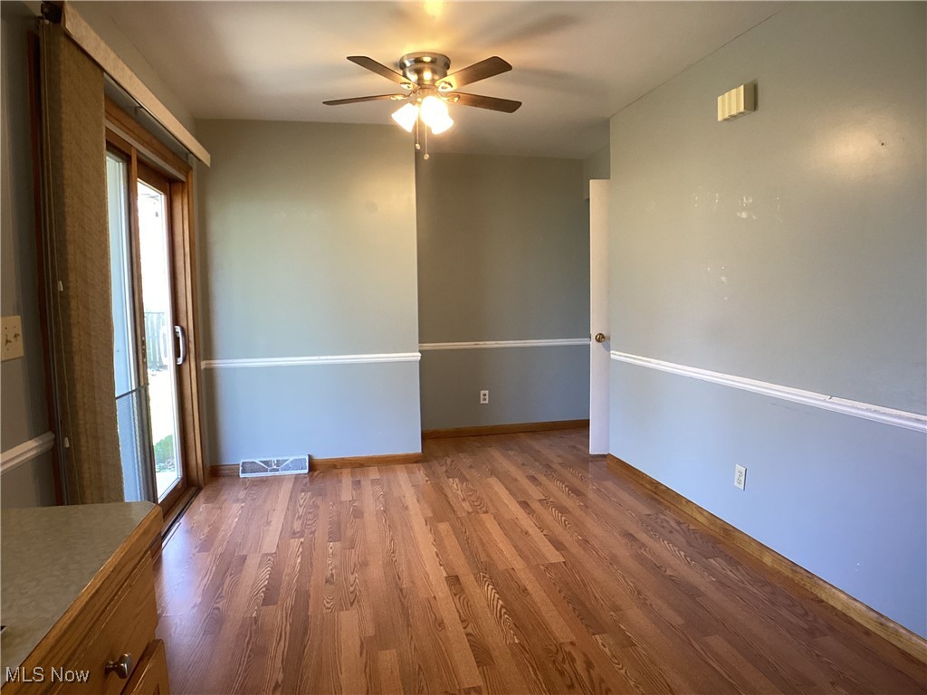 9083 Priem Road Strongsville, OH 44149 - Photo 7 of 28 Spare room featuring ceiling fan, baseboards, wood finished floors, and visible vents