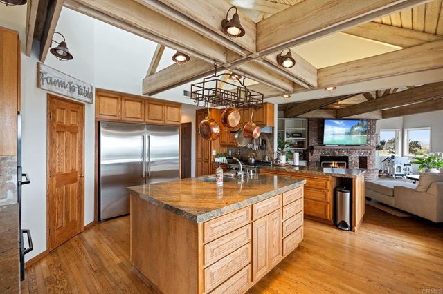 a living room with furniture a fireplace a flat screen tv and a large window