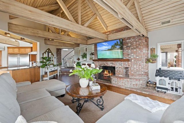 a view of a patio with table and chairs potted plants and palm trees
