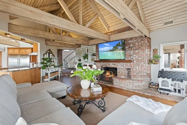 a view of a patio with table and chairs potted plants and palm trees