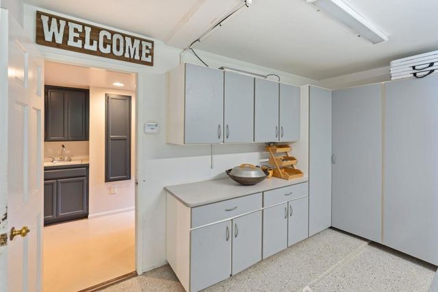 a living room with furniture a fireplace and wooden floor