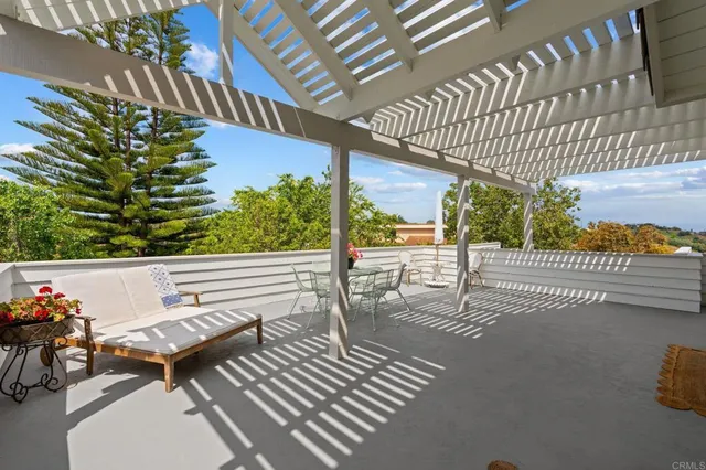 a living room with furniture a fireplace and a floor to ceiling window