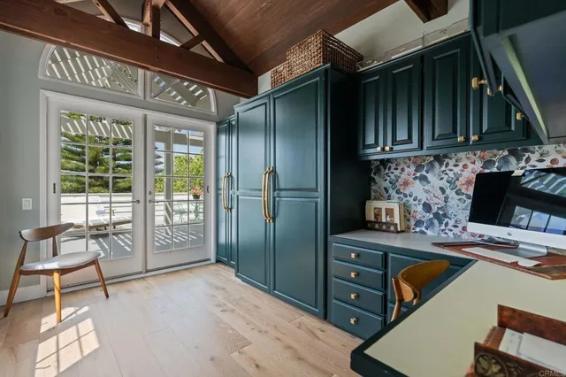 a living room with furniture a large window and a potted plant